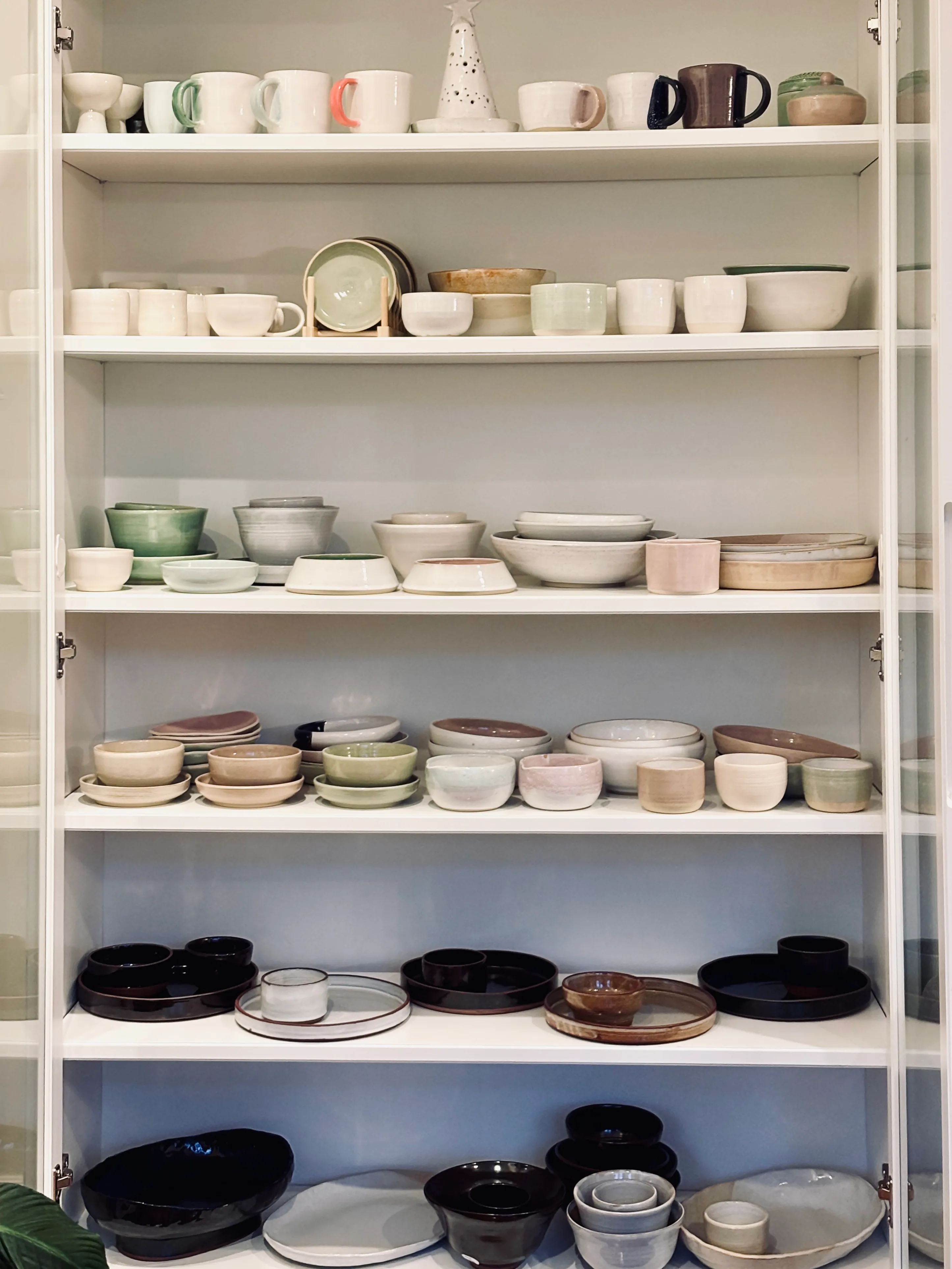 A cabinet of finished work in mixed glazes